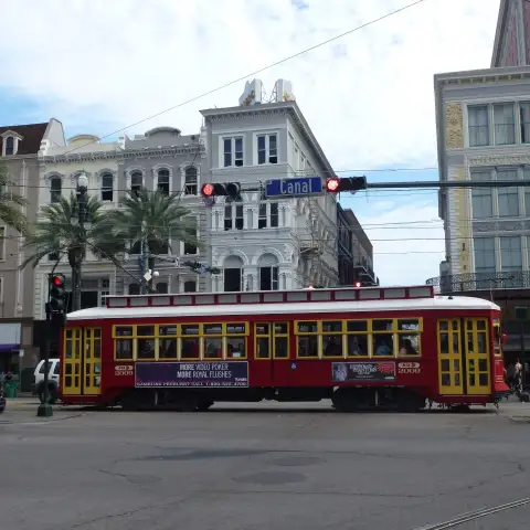a bus driving down a street in front of a building