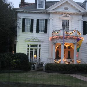 a large brick building with grass in front of a house
