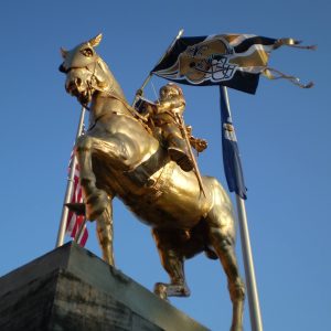 a statue of a bird flying in the sky