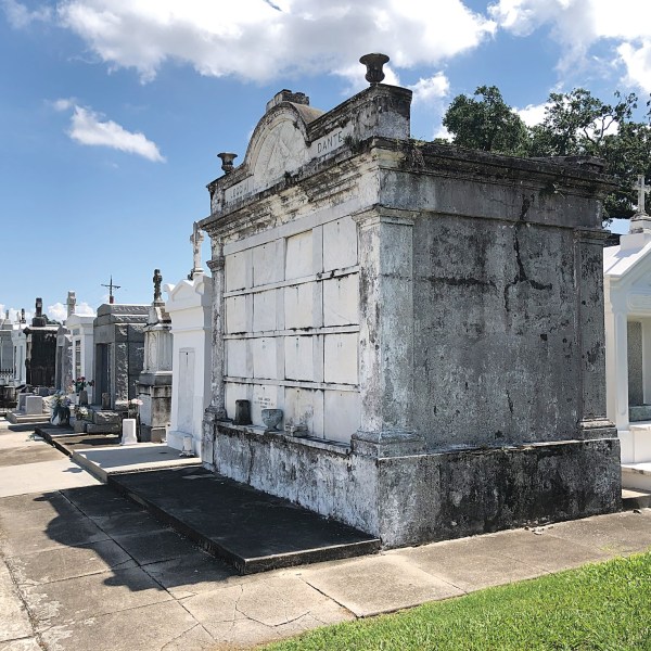 a large stone statue in front of a building