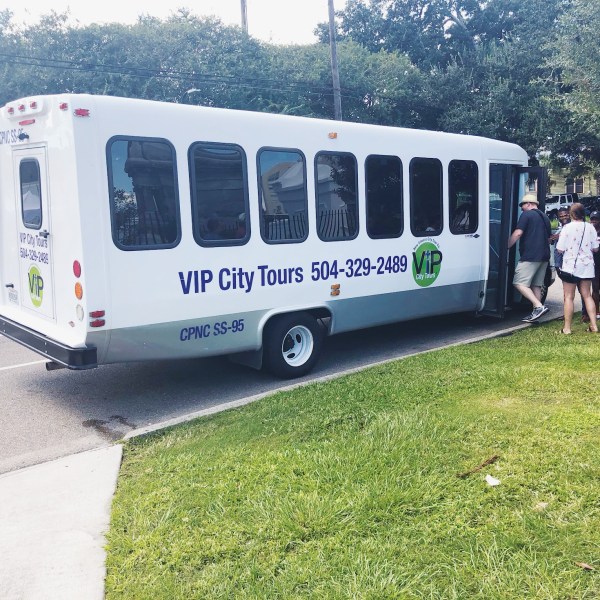 a passenger bus that is sitting in the grass