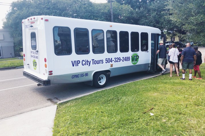 a passenger bus that is sitting in the grass