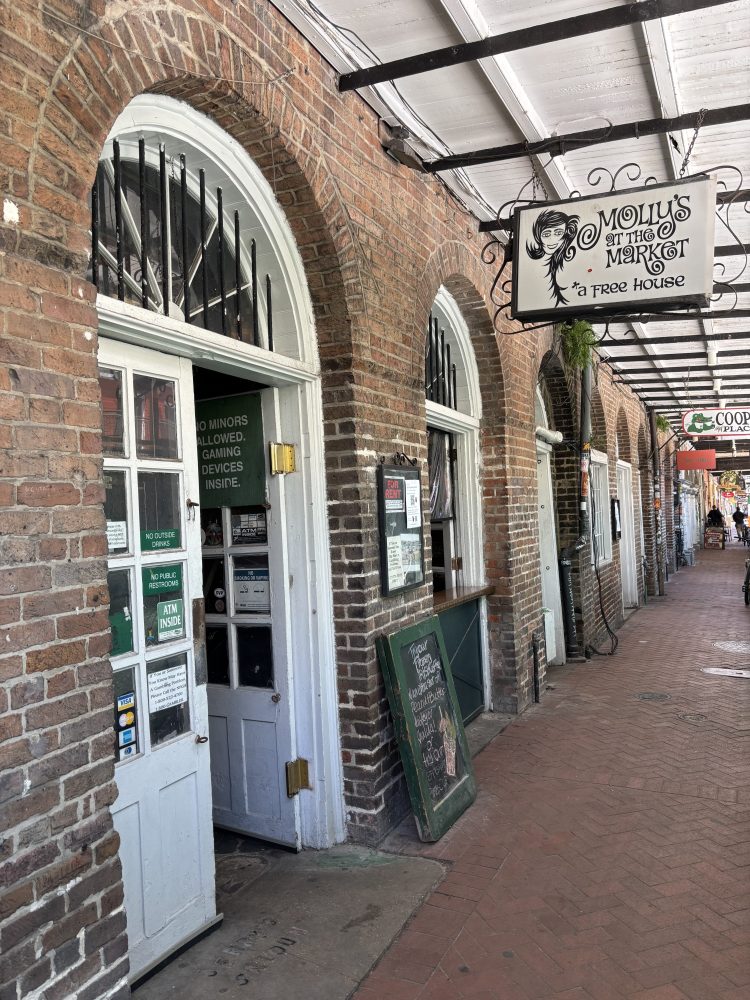 Brick exterior of Molly's Poison Bar and Tree House with arched windows.